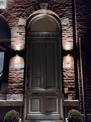 a door on a brick building with an arch at Leopold Appartementen & studio's in Sint-Truiden