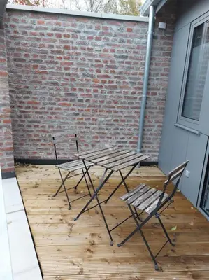 two chairs and a picnic table on a patio at Aux six fontaines in Herve