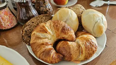 a plate of croissants and bread on a table at B&B Pippa in Peer