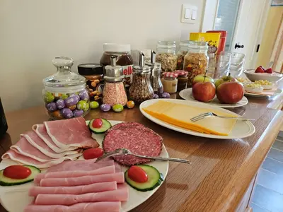 a table topped with plates of meat and fruit at B&B Pippa in Peer