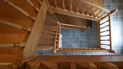 a spiral staircase in a room with blue tiles at B&B Pippa in Peer