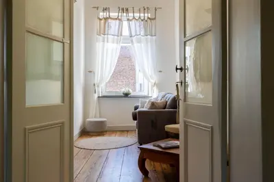 a living room with a couch and a window at Huis van Loon in Borgloon