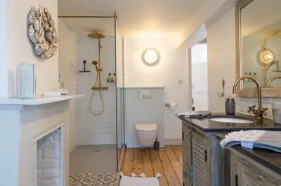 a bathroom with a shower and a sink and a toilet at Huis van Loon in Borgloon
