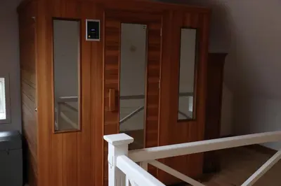 a stairway with a wooden door with glass panels at Country house Clos des hortensias in Blégny