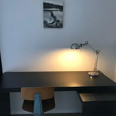 a desk with a lamp sitting on top of it at Magnifique appartement 1ch en Outremeuse in Liège