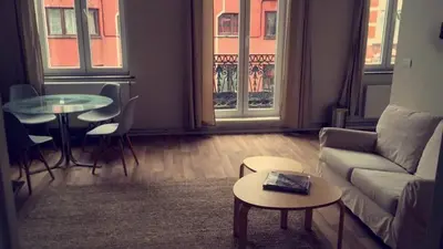 a living room with a couch and a table at Magnifique appartement 1ch en Outremeuse in Liège