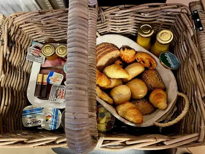 a basket filled with bread and other food items at Logies Op 't Gestel in Oudsbergen