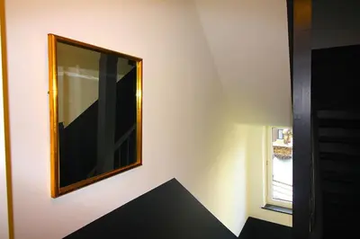 a mirror on a wall next to a window at Duplex de 3 chambres en plein centre ville - 82/3A in Liège