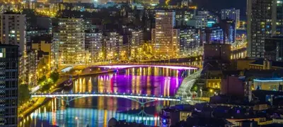 a lit up bridge in a city at night at Appartement 021 in Liège