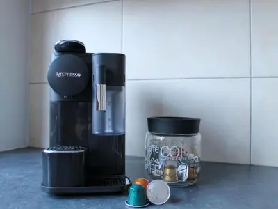 a coffee maker and a glass jar with coins in it at Retreat near Maasmechelen in Lanaken