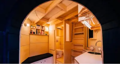 a small kitchen with an archway in a tiny house at Le pigeonnier - TinyHouse en plein centre de Liège in Liège