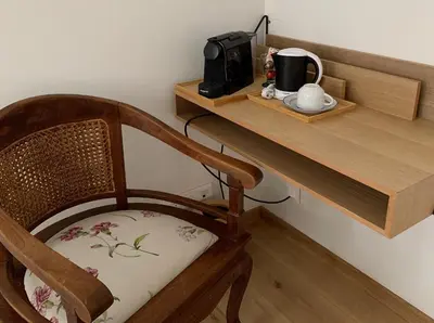 a wooden desk with a chair with a coffee maker on it at Bonjour Pierreuse in Liège