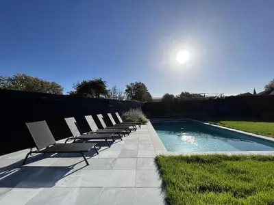 a row of chairs sitting next to a swimming pool at Bigaro II in Heers