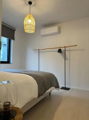 a bedroom with a bed and a pendant light at Duplex hyper centre in Liège