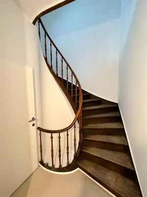 a spiral staircase in a house with a stair case at Duplex hyper centre in Liège