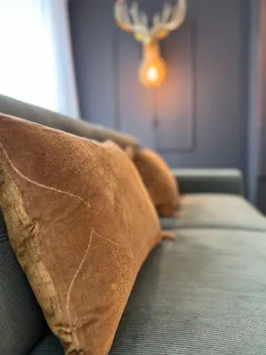 a row of brown pillows on a couch with at Red cross street in Lommel