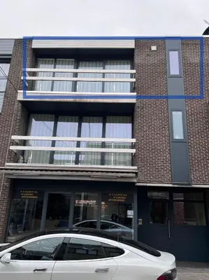 a white car parked in front of a building at Red cross street in Lommel