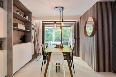a kitchen and dining room with a yellow table and chairs at Bos-Chalet bij Wijers Wandelroutes, Rust & Gezinsplezier Fijnspar 108 Hengelhoef in Houthalen-Helchteren