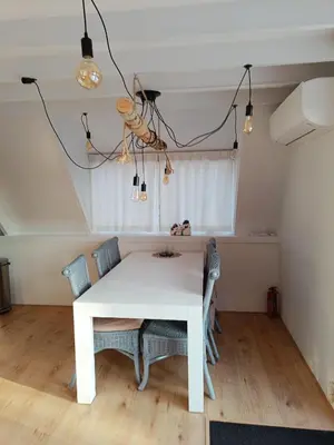 a dining room with a white table and chairs at Molière in Rekem