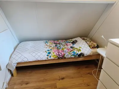 a small room with a bed in a small room at Molière in Rekem