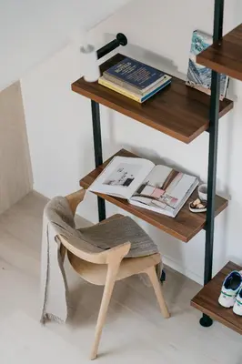 a chair sitting next to a desk with a book at MAM Haspengouw in Sint-Truiden