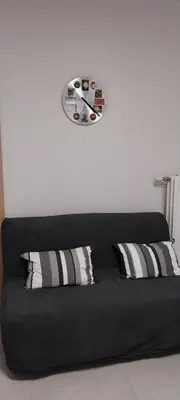 a black couch with two pillows in a room at Le Pepin Dort in Pepinster