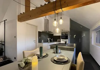 a kitchen with a table with two plates on it at Arcaden loft in Sint-Martens-Voeren
