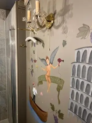 a bathroom with a painting of a fairy on the wall at B&B Els in Locht