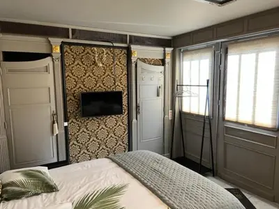 a bedroom with a bed and a wall with windows at B&B Els in Locht