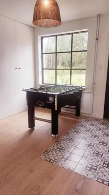 a room with a pool table in front of a window at Vakantiehuis Zand7 in Lommel
