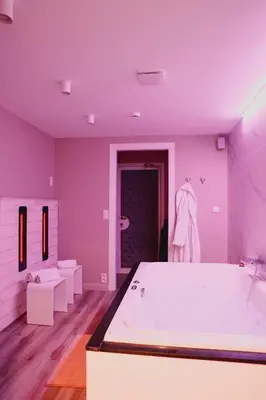 a purple bathroom with a tub and a sink at Hôtel Mademoiselle in Liège