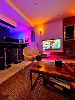 a living room with a table and a tv at Superbe appartement chic et design in Seraing