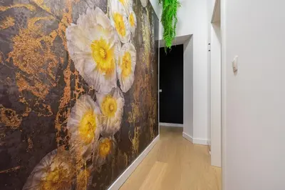 a painting of flowers on a wall in a hallway at The 99, Appartement sauna & parking in Liège