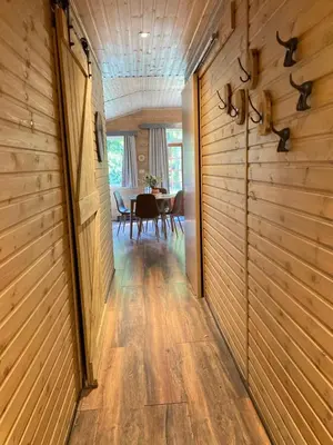 a hallway leading to a dining room with a table at Het Zenhuisje in Lanaken