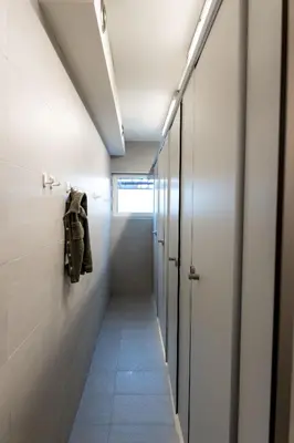 a hallway with white walls and a ceiling with lights at Parkvilla Vakantiehuis voor 23 personen in Heusden - Zolder