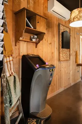 a tv in a room with a wooden wall at Time - Out Genoelselderen in Riemst