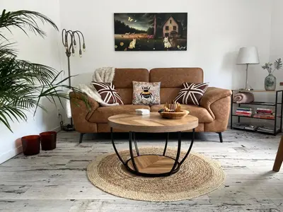 a living room with a couch and a table at Het Veldhuis in As