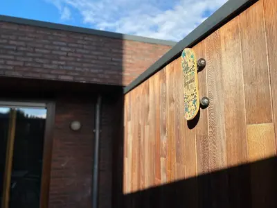 a wooden door with a skateboard hanging on it at Casper House, Near Maastricht in Lanaken